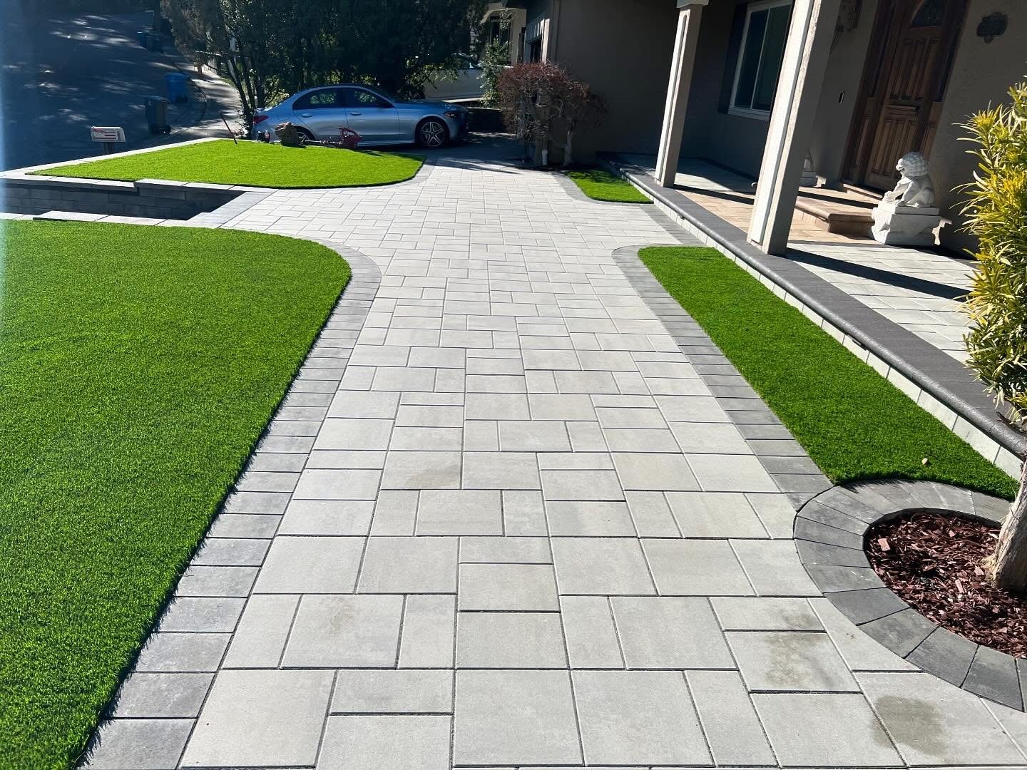 Elegant curved walkway with artificial turf borders