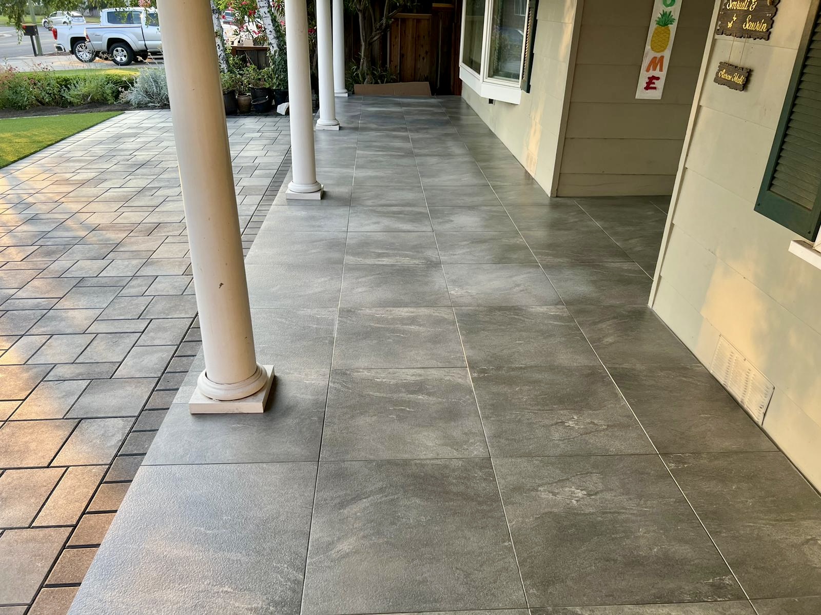 Elegant porch with large format tiles and paver walkway
