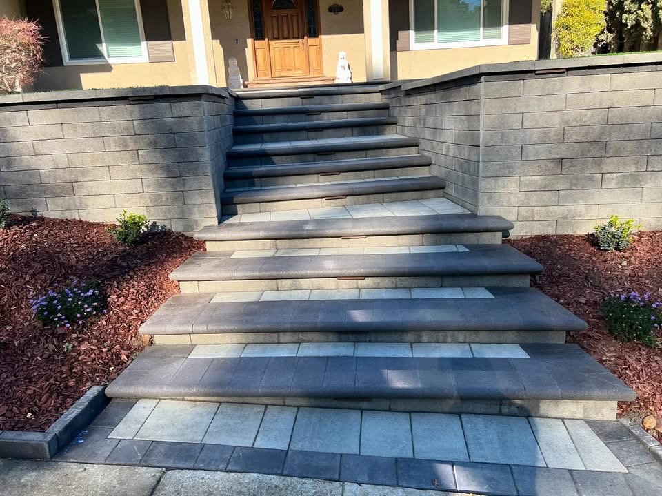 Custom stone steps with retaining walls leading to front entrance